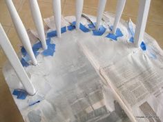 some blue tape is taped to the bottom of a paper towel holder with white poles