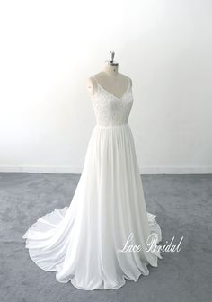 a white wedding dress on a mannequin in front of a white wall with the words love bridal