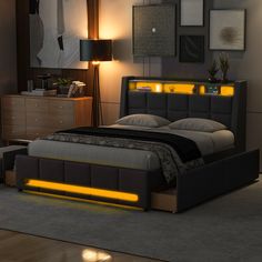 a bed that has some lights on the headboard and night stands in front of it