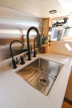 a kitchen sink and faucet in a small room