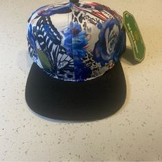 Sit Poolside In This Floral Hat Nwt Blue Flat Bill Baseball Cap For Spring, Blue Flat-brim Snapback Hat For Spring, Blue Flat Brim Snapback Hat For Spring, Blue Snapback Hat With Flat Brim For Spring, Blue Adjustable Snapback Hat For Spring, Blue Snapback Visor Hat For Spring, Blue Visor Snapback Hat For Spring, Blue Visor Snapback Hat, Multicolor Flat Brim Snapback Hat For Spring