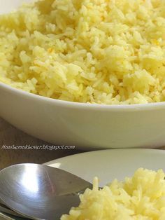 a white bowl filled with rice on top of a wooden table