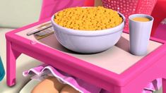 a bowl of cereal sitting on top of a pink table