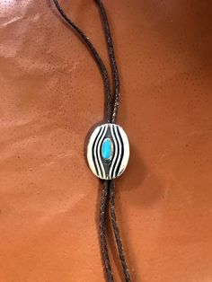 This Sterling Silver and Turquoise Bolo Tie was designed and hand crafted by me. It measures 2 1/4 by 1 3/4 inches. It works well on a 1 1/4 or 1 inch belt. Belt is not included. Turquoise is from the Kigman Arizona mine and hand cut by me. This is very heavy and would last for ever. The first three pictures show with oxidation and you can choose how you like it. Comes with sterling silver tips which are not shown. Other custom tip can be made for an additional charge. Southwestern Blue Bolo Ties As A Gift, Southwestern Blue Bolo Tie For Gift, Blue Handmade Bolo Tie Gift, Silver Bolo Tie, Handmade Artisan Turquoise Bolo Ties, Artisan Handmade Turquoise Bolo Ties, Southwestern Style Sterling Silver Bolo Tie, Western Style Sterling Silver Bolo Tie, Silver Sterling Bolo Tie