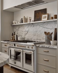 a kitchen with marble counter tops and an oven