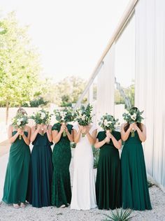 the bridesmaids are wearing green dresses and holding their bouquets