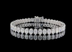 Made to Order-13.00+ctw 14k White Gold Oval Cut Lab Grown Diamond Tennis Bracelet 😍✨ ----------------------------------------- Diamond Type: Lab Grown Diamonds Diamond Total Weight: 13..00cts. + Each Diamond Weight: .35ct -.40ct. each  Diamond Color: DEF Diamond Clarity: VS+ Diamond Measurement: 5.45mm x 3.85mm *Please note the bracelet pictured is 7 inches long and has a tcw. of 13.00cts. If your size is smaller or larger than a size 7, the tcw. will slightly vary.* To have this bracelet certi Oval Tennis Bracelet With Prong Setting For Anniversary, Oval Brilliant Cut Tennis Bracelet For Anniversary, Oval Diamond Cut Tennis Bracelet, Oval Diamond White Diamond Bracelet For Anniversary, Oval Brilliant Cut Diamond Bracelet For Anniversary, Brilliant Cut Oval Diamond Bracelet For Anniversary, White Oval Diamond Bracelet As Gift, White Oval Diamond Bracelet For Gift, Anniversary Oval Diamond Bracelet With Brilliant Cut