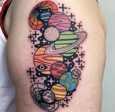 a woman's thigh with an image of the planets and stars tattoo on it