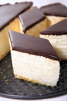 several pieces of cake sitting on top of a black plate