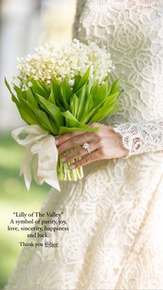 a woman holding a bouquet of flowers in her hand