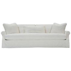 a white couch with four pillows on it