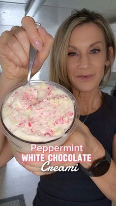 a woman is holding a bowl of white chocolate ice cream with peppermint on top