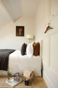 a bedroom with a bed, nightstand and pictures on the wall