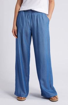 Lightweight chambray pants are cut with flowy wide legs and topped with a comfortable elastic waist. 31 1/2" inseam; 26" leg opening; 11 1/2" front rise; 15" back rise (size Medium) Elastic waist Front slant pockets; back welt pockets 100% Tencel® lyocell Tencel lyocell is a sustainably produced fiber made with closed-loop processing Machine wash, line dry Imported Solid Color Wide Leg Pants With Relaxed Fit, Relaxed Fit Wide Leg Pants With Pull-on Style, Relaxed Fit Wide Leg Pull-on Bottoms, Spring Wide Leg Tencel Pants, Denim Blue Tencel Straight Leg Bottoms, Relaxed Wide Leg Trousers With Elastic Waistband, Casual Wide Leg Pants For Beach, Wide Leg Tencel Pants With Pockets, Relaxed Full-length Pants With Elastic Waistband