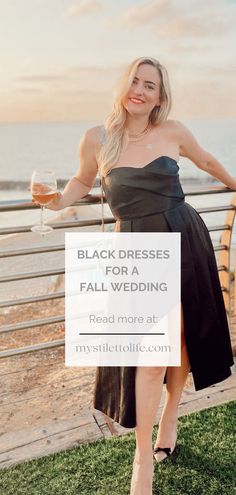 a woman in a black dress holding a glass of wine with the words, black dresses for fall wedding read more at my style boutique