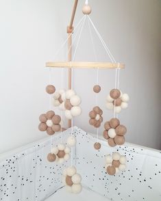 a crib mobile with balls hanging from it