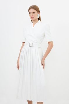 Meet The Everlasting Style Icon - The Forever Dress. A Timeless Addition To Any Well-Considered Wardrobe, This Piece Features A High Notched Collar, V-Neck Front, A Fit And Flare Silhouette, And A Belted Waist. Feel Elevated In Our Midi Dress, As The Pleated Skirt Moves With You, And The Structured Shoulders Bring The Drama. Style It With Heels Or Loafers For An Elevated Daytime Look, Perfect For Year-Round Wear. Structured Crepe Notch Neck Wrap Belted Forever Midi Dress High Quality Crepe Fabri Elegant V-neck Dress With Fitted Waist, Elegant White A-line Dress, Tailored V-neck Spring Dress, Tailored V-neck Dress For Spring, Spring Fitted Belted Dress With Pleated Waist, Classic Cream Office Dress, Spring V-neck Dresses With Structured Shoulders, White Elegant Dress With Fitted Bodice, Elegant White Dress With Fitted Bodice