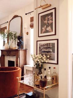 a living room filled with furniture and pictures on the wall