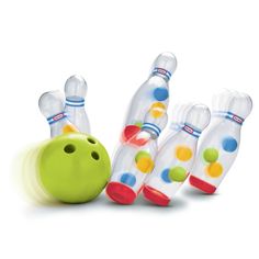 three plastic bowling balls and one green bowling ball on a white background with colorful polka dots