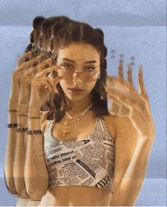 a woman wearing glasses and holding her hands up to her face