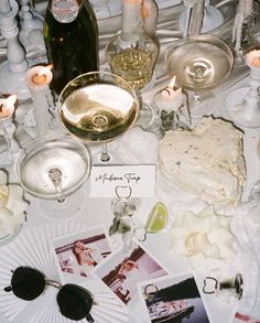 a table topped with lots of different types of food and glasses on top of it