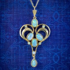 A beautiful Edwardian inspired necklace fashioned in Sterling Silver and gilded in 18ct Yellow Gold. It features a fabulous heart shaped pendant collet set with ten, mesmerising Cultured Opals which shimmer and change colour as they catch the light.   It's very eye catching and a wonderful, distinct design.   WEIGHT: 3.8 grams - 4.8 grams with chain   PENDANT MEASURES: Height 45mm x Width 24mm x Depth 3.5mm CHAIN MEASURES: 18 inches METAL: Sterling Silver, gilded in 18ct Gold STONES: Cultured Op Bijoux Art Nouveau, Edwardian Jewelry, Heart Shaped Pendant, Edwardian Style, Opal Pendant Necklace, Inspired Necklace, Art Nouveau Jewelry, Gold Heart Necklace, Edwardian Fashion