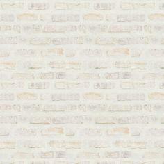 a white brick wall textured with light brown bricks