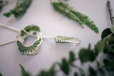 This necklace is formed of 2 different pieces made in clear resin, with real Ferns inside them, a Geode shaped and a pointed crystal. You can adapt it to your neck and wear it in different ways. Because the ferns are real, it can be sightly different from the original photos, but will always have the same quantity of leaves. Nature-inspired Green Pendant Crystal Necklace, Fern Necklace, Pressed Flower Jewelry, Necklace Resin, Geode Slice, Resin Necklace, Flower Jewelry, Pressed Flower, Clear Resin