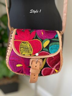 Embroidered Genuine Leather Bag Dare to be bold and adventurous with our Handcrafted Leather Purse, carefully crafted in Chiapas Mexico by our skilled partners. Made with genuine leather and adorned with exquisite embroidery, this purse exudes elegance and sophistication. The 7"x8" dimensions provide ample space for your essentials, while the 8 inch strap allows for easy and comfortable wear. Elevate your look and add a touch of Mexican flair to your outfit with this unique and striking accessor Festival Embroidered Leather Shoulder Bag, Leather Bag With Multicolor Embroidery For Everyday Use, Leather Bag With Floral Embroidery And Rectangular Shape, Rectangular Leather Bag With Floral Embroidery, Leather Shoulder Bag With Floral Embroidery For Travel, Festival Leather Embroidered Bags, Festival Embroidered Leather Bags, Embroidered Leather Bags For Festivals, Embroidered Leather Crossbody Bag