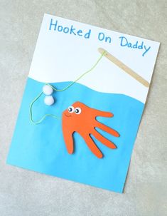 an orange octopus is hooked up to a fishing pole and floating on the ocean water