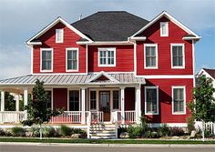 a red two story house with white trim