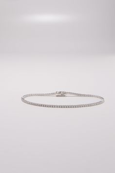 PLX470 Our 1.5mm CZ Tennis Bracelet is meticulously handcrafted in Korea, delivering a unique blend of classic and contemporary aesthetics. Made from 14K solid white gold, this bracelet features a tennis design adorned with cubic zirconia stones, providing a timeless and elegant look. This bracelet is perfect for adding a touch of elegance and sparkle to your everyday look or for special occasions. This tennis bracelet also makes a great gift for occasions like birthdays, holidays, or simply to White Brilliant Cut Tennis Bracelet For Everyday Luxury, Everyday Luxury White Brilliant Cut Tennis Bracelet, Luxury White Jubilee Tennis Bracelet, Modern White Jubilee Tennis Bracelet, Classic White Gold Tennis Bracelet For Everyday Luxury, Timeless White Tennis Bracelet With Brilliant Cut, Modern White Gold Tennis Bracelet For Formal Occasions, Silver Sterling Silver Tennis Bracelet For Everyday Luxury, Fine Jewelry Silver Tennis Bracelet For Everyday Luxury