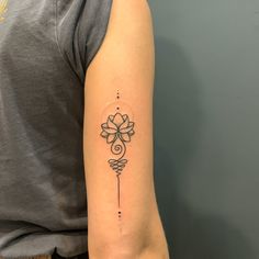 a woman's arm with a tattoo on it and a flower in the middle