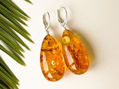 "Massive natural Baltic amber cognac color earrings is a perfect choice for classy style admirers! Perfect choice to brighten up office outfit or look even more beautiful on a special occasion! Shaped in drop form these earrings are the best example of royal and unforgettable jewelry. MATERIALS AND SIZE: Stone: 100% Natural Baltic Amber Findings: sterling silver 925 Weight: 11,3 g (0,39 oz) Bead size: 3,7 cm (1,45 in) x 1,9 cm (0,74 in) Total earring lenght: 5,7 cm (2,24 in) PLEASE NOTE: All our Classic Amber Earrings For Formal Occasions, Amber Earrings For Gift, Elegant Handmade Amber Earrings, Elegant Amber Dangle Earrings, Elegant Amber Teardrop Earrings, Handmade Elegant Baltic Amber Earrings, Elegant Baltic Amber Teardrop Earrings, Elegant Amber Earrings For Formal Occasions, Elegant Handmade Baltic Amber Earrings