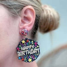 a close up of a person wearing earrings with the words happy birthday written on it