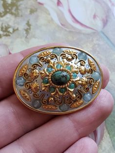 This is a vintage Micheal Golan, oval, gold tone metal, geometric pin or brooch or it can be worn as a pendant, in shades of blue. This measures just shy of 1.75 x just over 1.25 inches. Don't forget to stop in at my other Etsy shop... http://www.etsy.com/shop/xtdesigns. Follow me on Twitter at... MyYiayiaHadThat@MyYiayiaHadThat. If you have a wish list or are looking for something specific, please ask. I may have exactly what you are looking for. As always please convo me with any questions or Ornate Gold Cabochon Brooches, Antique Gold Oval Brooch, Antique Gold Oval Brooches, Handmade Brass Gold Brooches, Handmade Gold Brass Brooches, Gold Cabochon Brooches For Jewelry Making, Antique Gold Brooch With Oval Cabochon, Antique Gold Oval Cabochon Brooch, Antique Gold Brooches With Oval Cabochon