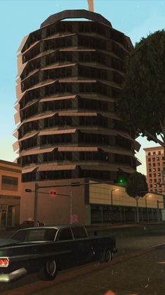 a black car parked in front of a tall building