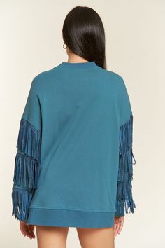 Expertly crafted with a suede silver studded fringe trim at the sleeve, this oversized top boasts ribbed hems and exposed seaming for a unique and stylish look. The dropped shoulder and long sleeve design adds comfort and versatility. Made from a blend of 85% cotton and 15% polyester, this top is both soft and durable. Elevate your wardrobe with this statement piece. -Suede silver studded fringe trim at sleeve-Oversized fit-Ribbed hems-Exposed seaming-Pullover-Dropped shoulder with long sleeve-8 Fringe Sweatshirt, Cocktail Dress Curvy, Fringe Sleeves, 4th Of July Dresses, Cocktail Dress Formal, Curvy Swimwear, Oversized Top, Fringe Trim, Plus Dresses