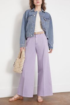 The Forte Forte Old Peach Gabardine Wide Leg Pants in Lavender exudes urban edge and contemporary cool. These wide–leg trousers are bound to astound with their feminine allure and the delicately romantic texture of the fabric. The faded effect of the brushed cotton gabardine and the candy colour palette temper this garment's formal restraint and set a languid mood. FIT DESCRIPTION This garment fits true to size, take your normal size. High-rise, wide leg, cut for a comfort fit Pants made in iIal Lavender Pants Outfit Winter, Pastel Colored Outfits Women, Lilac Wide Leg Pants Outfit, How To Style Lavender Pants, Lavender Pants Outfit Work, Purple Wide Leg Pants Outfit, Lavender Trousers Outfit, Lavender Pants Outfit, Lilac Pants Outfit