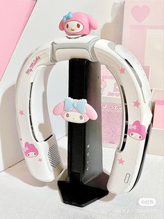 an electronic device with hello kitty on the front and back sides, attached to a stand