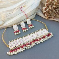 This Beautiful Meenakari White Colour Wedding Choker Necklace for Bride is very much in high trend gives you a real ethnic as well as royal look. Gold-toned Kundan Pearl Earrings have a floral base with stone-studded detail. This choker necklace set is designed for all age groups from college going girl to housewife. This is ... Festive White Meenakari Jewelry Sets, Ceremonial White Meenakari Jewelry Sets, Traditional White Jewelry With Mirror Work, Festive White Jeweled Kundan Necklace, White Jeweled Kundan Necklace For Festivals, White Meenakari Kundan Necklace For Ceremonial Occasions, Traditional White Meenakari Jewelry, Necklace For Bride, Wedding Choker Necklace