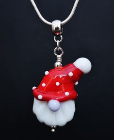 Christmas Gonk Gnome Lampwork glass bead pendant. The latest in my handmade glass bead collection red santa gonk with the sweetest nose, this is the cutest Christmas jewellery ever. He has a unique character all of his very own and will be a guardian gonk for Christmasor at least bring a smile to your face. Looking for a forever home and with a touch of magic he brings something current, out there and show stopping to your jewellery collection.  All of the glass is handmade so may have slight im Whimsical White Necklaces For Gifts, Whimsical White Necklace For Gift, Whimsical White Necklace Perfect For Gifts, Novelty Necklace With Lobster Clasp For Gift, Whimsical Necklaces For Gifts, Whimsical Pendant Charm Necklace, Novelty Pendant Charm Necklace As Gift, Novelty Pendant Charm Necklace Gift, Novelty Pendant Charm Necklace For Gift