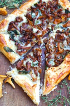 a pizza sitting on top of a wooden cutting board