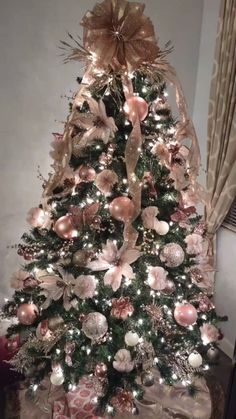 a decorated christmas tree with pink and gold ornaments