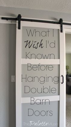 a sliding door with the words what i wish to know before hanging double barn doors