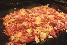 an uncooked pizza sitting on top of a pan in the oven with toppings