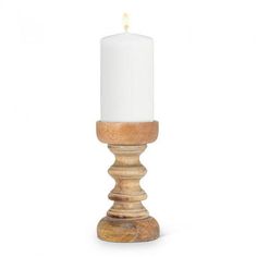 a wooden candle holder with a white candle