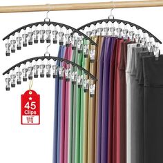 an assortment of colored umbrellas hanging on a rack with tags and clips attached to them