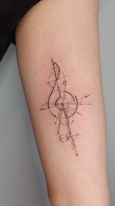 a woman's arm with a compass tattoo on it