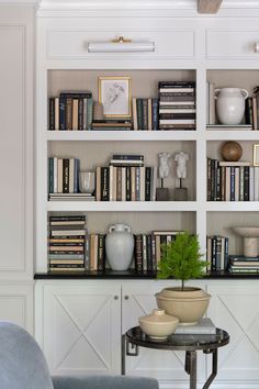 a living room filled with furniture and bookshelves